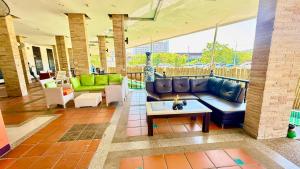 a living room with a couch and a table at APK Resort in Patong Beach