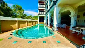 a swimming pool in the middle of a building at APK Resort in Patong Beach