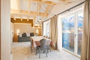 a dining room with a table and a couch at Residence Diamant in Andalo