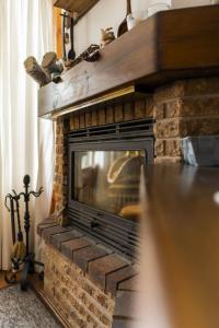 a living room with a brick fireplace at Ibon de Anayet in Formigal