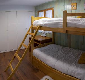 a bunk bed room with two bunk beds and a small bed at Ibon de Anayet in Formigal