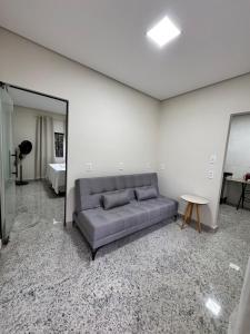 a living room with a couch and a mirror at Casa nova e confortavel, Itabirito, MG in Itabirito