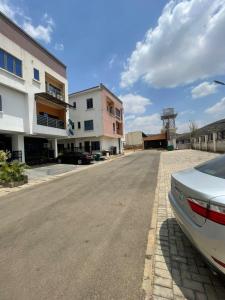 a car parked on the side of a street at Skybuilt Apartment in Abuja