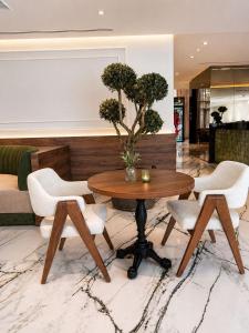 a living room with a table and chairs at L'ADRESSE Boutique Hôtel & SPA Tanger in Tangier