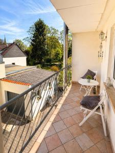 a balcony with a table and chairs on a house at Apartment Hope Inn in Groß-Zimmern