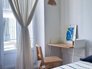 a bedroom with a bed and a desk and a window at Superbe appartement spacieux, calme, central in Toulon