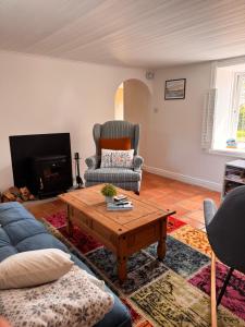 a living room with a couch and a coffee table at Sweet Lamb Farmhouse in New Ross