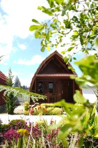 a small building in the middle of a garden at Noah Hotel Silangit in Siborongborong