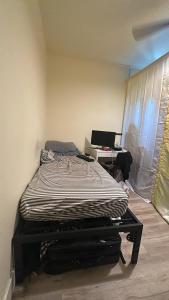 a bedroom with a bed and a desk with a laptop at Central LA Shared Living #2 in Los Angeles +6 photos