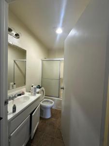 a bathroom with a toilet and a sink and a shower at Central LA Shared Living #2 in Los Angeles