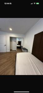 a bedroom with a bed and a kitchen and a table at Central LA Shared Living #2 in Los Angeles
