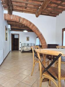 a living room with a wooden table and chairs at Agriturismo Settepassi Tuscany in Ponte Buggianese