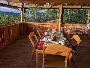 a dining room with a table and chairs on a porch at Aika Sunrise - Your Home in the Hills in Iringa +76 photos