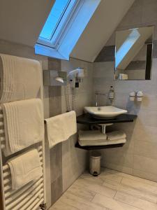 a bathroom with a sink and a mirror at Hôtel de l'Ange in Niedermorschwihr +111 photos
