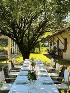 a long table with plates and wine glasses on it at Agriturismo Viridarium in Castellucchio