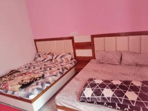 two beds sitting next to each other in a room at Royal Orbit By StayApart in Sonprayag +19 photos