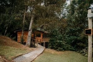 a log cabin in the woods with a tree at The Cabins Hogsback in Hogsback