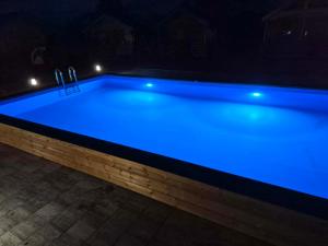 a pool with blue lights on top of it at Arcada in Jarosławiec