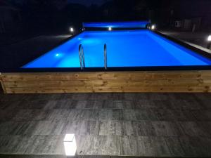 a swimming pool with a blue pool at Arcada in Jarosławiec