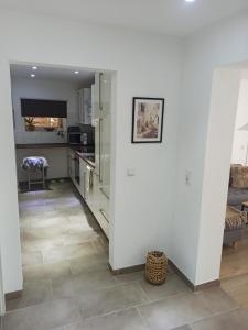 a kitchen with white walls and tile floors at Herdecke, Ruhrperle in Herdecke