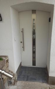 a white door with a silver handle on a building at Herdecke, Ruhrperle in Herdecke +5 photos