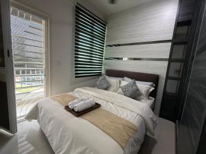 a bedroom with a large bed with a window at SPICE Skyview Luxe Tunas 3B2B in Relau +51 photos