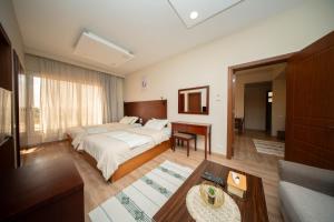 a hotel room with a bed and a desk at The Home Dreamland in 6th Of October +106 photos