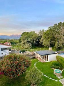 an aerial view of a yard with a house at The Eira - Spacious duplex with lush garden in Nigrán