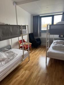 a room with two bunk beds and a chair at Sjømannskirken Narvik in Narvik +88 photos