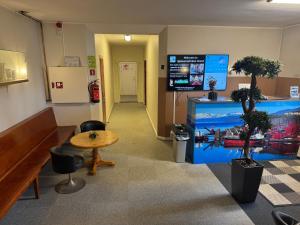 a waiting room with a table and a table and chairs at Sjømannskirken Narvik in Narvik