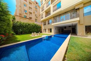a swimming pool in the backyard of a building at The Home Dreamland in 6th Of October