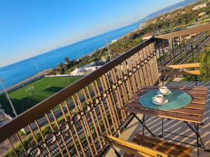 a table on a balcony with a view of the ocean at Miramare Apartment in Acquedolci