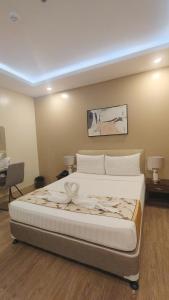 a bedroom with a large bed in a room at BEAVER HOTEL and RESIDENCES in Cebu City