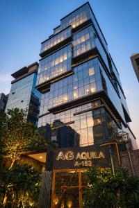 a tall building with a sign in front of it at Aquila Grand Suites - Noida Sector 136 in Noida