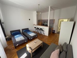 a living room with a couch and a table at Palace Apartment in Vienna