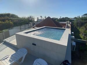 a swimming pool on the roof of a house at Calas De Meca in Los Caños de Meca