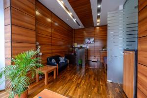a living room with wooden walls and a couch and a table at Samali Residence in Eforie Nord