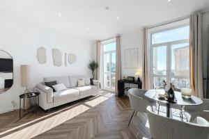 a white living room with a couch and a table at DELUXE SEAVIEW BALCONY - 2 min PALAIS & BEACH in Cannes
