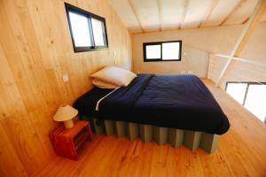 a bedroom with a bed in a small room at Le Chalet de la Boussonie in Les Vans