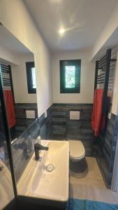 a bathroom with a sink and a toilet at Le Chalet de la Boussonie in Les Vans