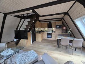 a large living room with a table and chairs at Haus Rosengarten 2 in Bad Wünnenberg