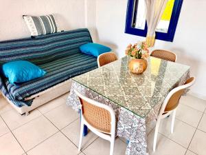 a table and chairs with a couch in a living room at Blue Thea in Lentas
