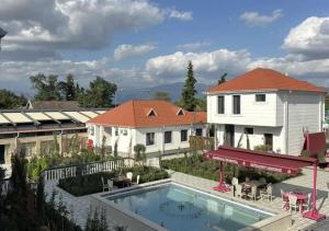 a view of a house and a swimming pool at Warm Welcome Ivanovka in İvanovka