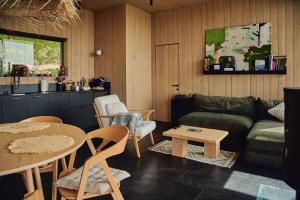 a living room with a couch and a table at Висота 890 in Volosyanka