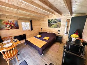 a bedroom with a bed in a wooden cabin at ARDENNE CAMPING MABOGE in La-Roche-en-Ardenne