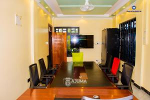 a conference room with a large table and chairs at The Grand Brystal Hotel in Busia