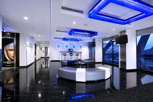 a lobby with a blue ceiling and a round table at StarRay Hotel Jakarta Kebayoran in Jakarta +12 photos