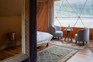 a room with a bed and a table and chairs at Camp The Sanga Manali in Tāndi