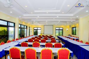 a conference room with tables and chairs and a whiteboard at The Grand Brystal Hotel in Busia