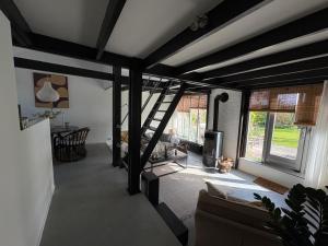 a living room with a spiral staircase in a house at Seasons in Warmenhuizen +25 photos